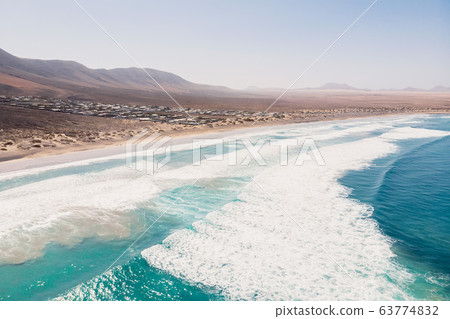Aerial view of Famara beach, landscape with blue ocean and mountains in Lanzarote, Canary islands 63774832