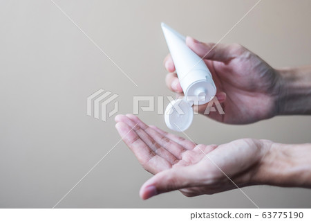 Man hands using wash hand alcohol gel or sanitizer Man hands using wash hand alcohol gel or sanitizer 63775190