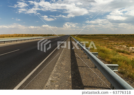 asphalt road in the steppe of Kazakhstan 63776318