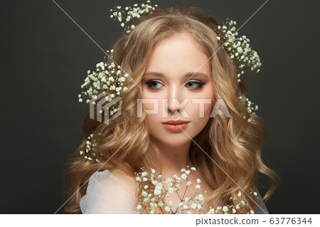 Cute woman with flowers on gray background 63776344