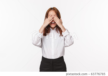 Portrait of excited upbeat smiling asian woman waiting for her surprise, counting ten to open eyes as standing blindfolded on b-day party friends bring gift, standing white background Portrait of excited upbeat smiling asian woman waiting for her surprise, counting ten to open eyes as standing blindfolded on b-day party friends bring gift, standing white background 63776785