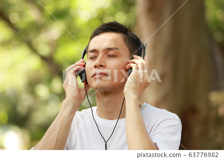 Men listening to music 63776982