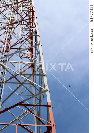 A towering telephone pole and a plane A towering telephone pole and a plane 63777331