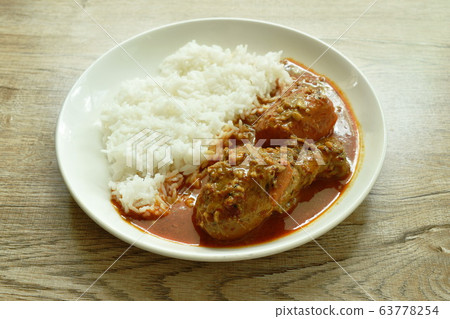 chicken leg spicy and sweet curry or mussaman eat with plain rice on dish chicken leg spicy and sweet curry or mussaman eat with plain rice on dish 63778254