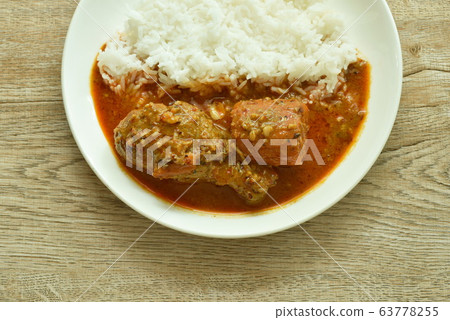 chicken leg spicy and sweet curry or mussaman eat with plain rice on dish chicken leg spicy and sweet curry or mussaman eat with plain rice on dish 63778255