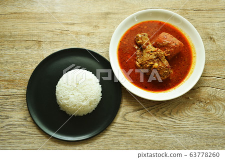 chicken leg spicy and sweet curry or mussaman eat with plain rice on dish 63778260