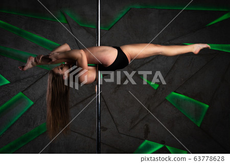 Beautiful girl training on the pole at studio Beautiful girl training on the pole at studio 63778628