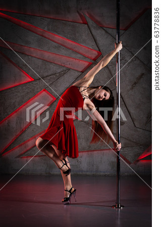Beautiful girl dancing on the pole at studio 63778836