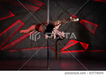 Beautiful girl dancing on the pole at studio 63778844