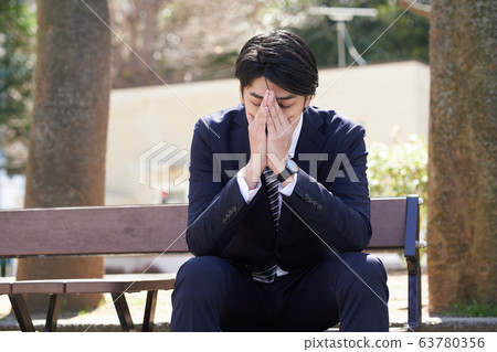 Japanese male businessman worried about worries Japanese male businessman worried about worries 63780356