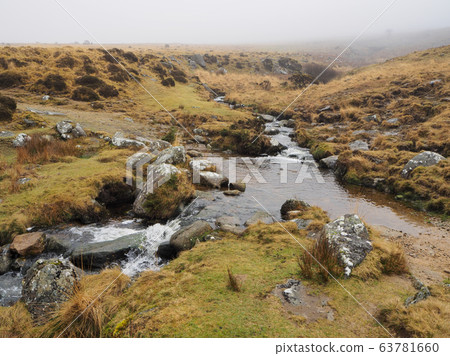 Footpath across Red-a-ven Brook as it cascades over rocks below mist and low cloud, Dartmoor National Park, Devon Footpath across Red-a-ven Brook as it cascades over rocks below mist and low cloud, Dartmoor National Park, Devon 63781660