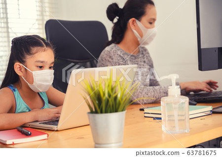 mom working at home with her child on the table mom working at home with her child on the table 63781675
