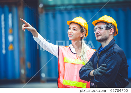 logistic worker man and woman working team with radio control loading containers at port cargo logistic worker man and woman working team with radio control loading containers at port cargo 63784700