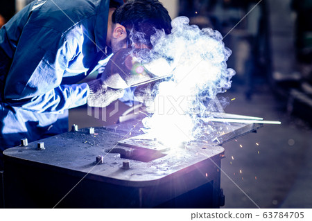 worker welding metal working in steel heavy industry manufacturing. worker welding metal working in steel heavy industry manufacturing. 63784705
