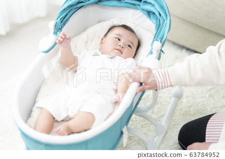 7 month old girl lying on bouncer 7 month old girl lying on bouncer 63784952