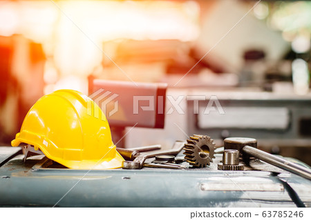 yellow helmet hardhat with instruments gear tools in factory for background. 63785246