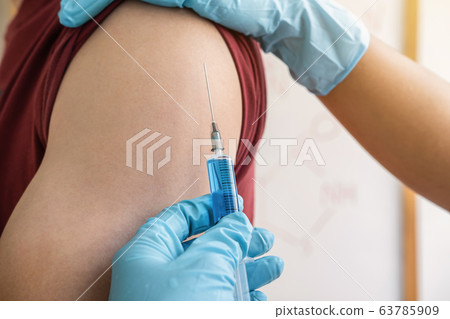 Doctor making injection vaccination patient to 63785909
