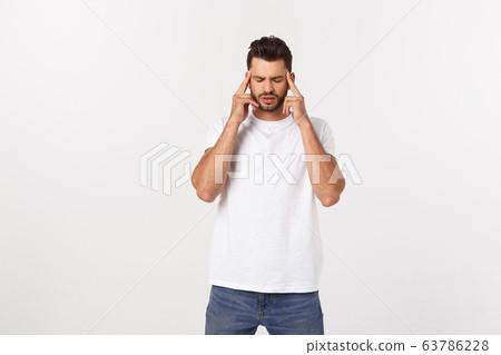 Handsome young man touching his head with hand feeling strong headache. Isolated over white background Handsome young man touching his head with hand feeling strong headache. Isolated over white background 63786228