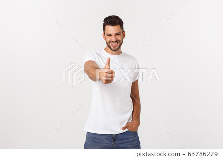 Young happy man with thumbs up sign in casuals isolated on white background Young happy man with thumbs up sign in casuals isolated on white background 63786229