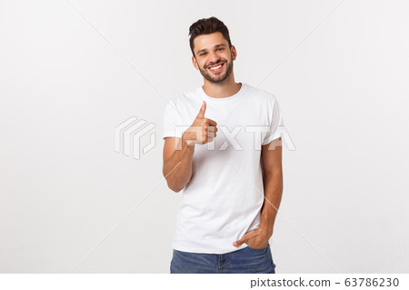 Young happy man with thumbs up sign in casuals isolated on white background Young happy man with thumbs up sign in casuals isolated on white background 63786230