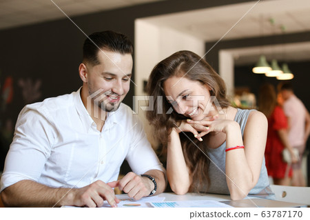 Young successful businessman and wife working with documents. Young successful businessman and wife working with documents. 63787170