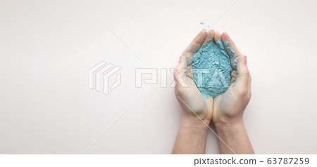 Blue powder paint in hands for Holi Blue powder paint in hands for Holi 63787259
