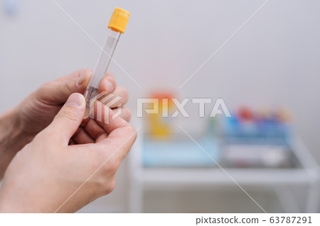 Close-up of doctor in the laboratory with a blood tube for analysis. Close-up of doctor in the laboratory with a blood tube for analysis. 63787291