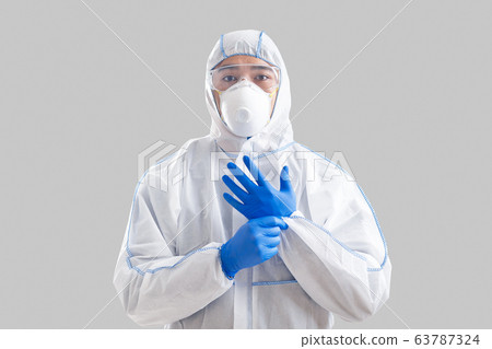 Asian man puts on protective suit and gloves Asian man puts on protective suit and gloves 63787324