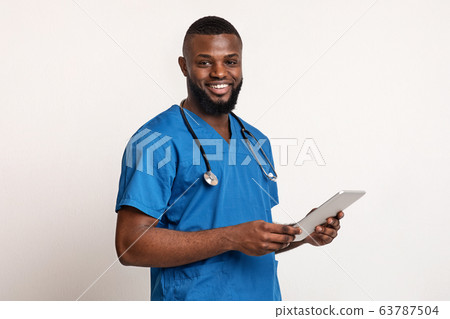 Happy african therapist with digital tablet over white background Happy african therapist with digital tablet over white background 63787504