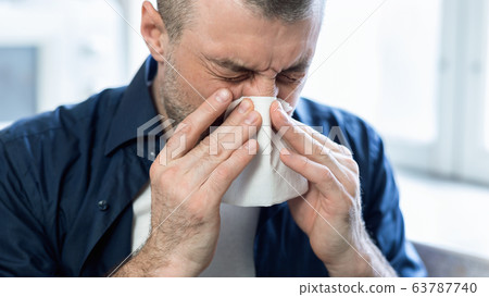 Sick Man Blowing Nose In Paper Tissue At Home, Panorama Sick Man Blowing Nose In Paper Tissue At Home, Panorama 63787740
