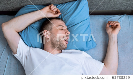 Man Sleeping In Bed At Home During Pandemic Self-Isolation, Panorama Man Sleeping In Bed At Home During Pandemic Self-Isolation, Panorama 63788239