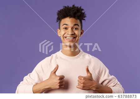 Close-up portrait of enthusiastic handsome young teenage guy, college student recommend awesome courses, online education school, show thumbs-up as recommending, like and approve, smiling 63788873