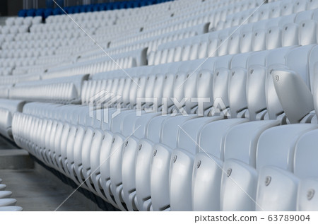 Empty white seats at the american football stadium during isolation period 63789004