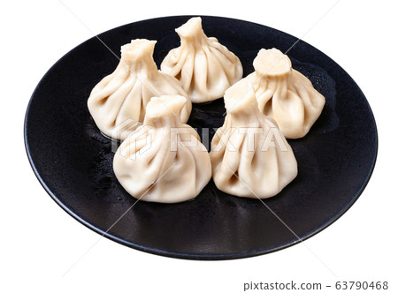 portion of boiled khinkali on black plate isolated portion of boiled khinkali on black plate isolated 63790468