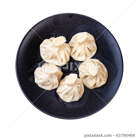 top view of five khinkali on black plate isolated top view of five khinkali on black plate isolated 63790469