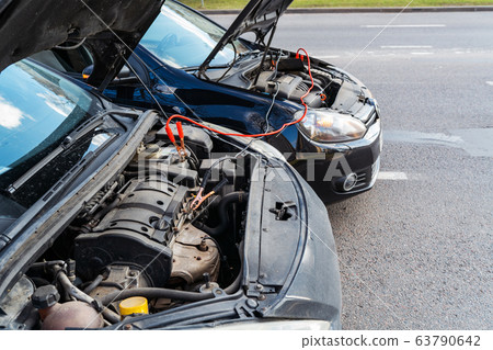 Jump cables on car battery 63790642
