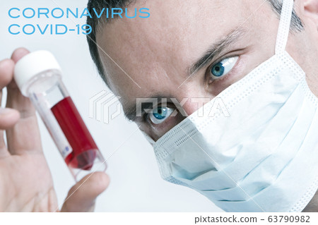 Doctor wearing Face Mask With Coronavirus COVID-19 blood sample. Picture with text. Doctor wearing Face Mask With Coronavirus COVID-19 blood sample. Picture with text. 63790982
