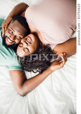 Beautiful couple lying on the bed stock photo 63793620