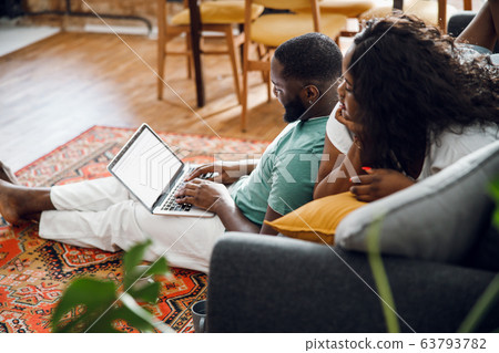 Afro American couple relaxing in the living room stock photo 63793782
