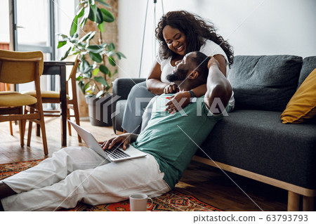 Happy woman leaning to boyfriend at home stock photo 63793793