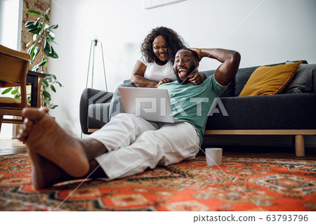 Excited couple watching sports on laptop stock photo 63793796