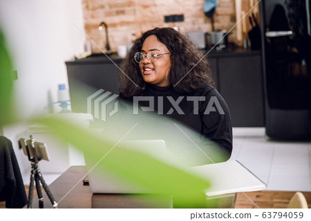 Mirthful woman at home smiling in the kitchen stock photo 63794059