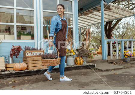Smiling beautiful girl carrying purple sage flowers 63794591