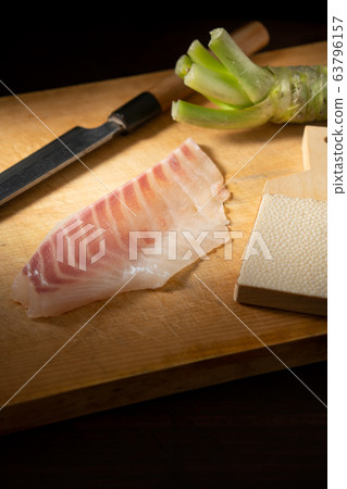 Sashimi and wasabi on a cutting board 63796157