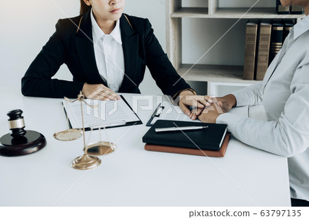 Lawyer is counseling the client in his counsel and Lawyer is counseling the client in his counsel and 63797135