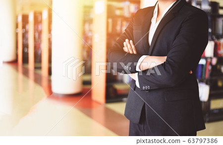 businessman standing in a office - smart business businessman standing in a office - smart business 63797386