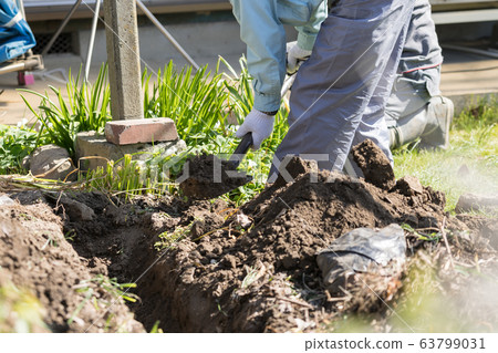 Digging with a scoop Digging with a scoop 63799031