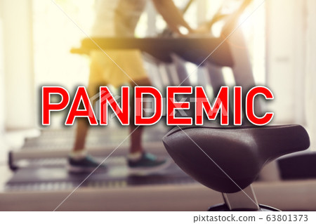 Sign PANDEMIC over man doing sports at gym Sign PANDEMIC over man doing sports at gym 63801373