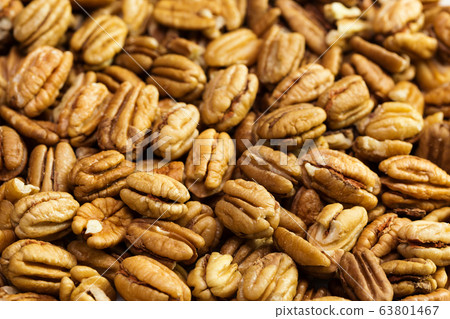 Pecan nuts background. Closeup pekan seeds 63801467