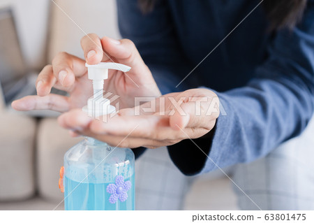 Asian women clean hand with alcohol gel sanitizer Asian women clean hand with alcohol gel sanitizer 63801475